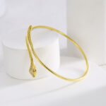 Wholesale European-style minimalist snake cuff bracelet featuring a 14k gold plated copper design with CZ stone detailing from junejewelry.com