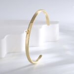 Wholesale European-style minimalist cross cuff bracelet featuring a 14k gold plated copper design from junejewelry.com