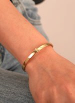 Wholesale European-style minimalist cross cuff bracelet featuring a 14k gold plated copper design from junejewelry.com