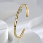 Buy wholesale triangle cuff bracelets. Simple, stylish, and adjustable, these 14K gold and platinum plated open cuff bracelets feature a modern triangle texture with CZ stone detailing. Free shipping at junejewelry.com.