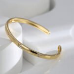 Buy wholesale triangle cuff bracelets. Simple, stylish, and adjustable, these 14K gold and platinum plated open cuff bracelets feature a modern triangle texture with CZ stone detailing. Free shipping at junejewelry.com.