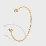 Wholesale European-style minimalist CZ cuff bracelet featuring a 14k gold plated copper design from junejewelry.com