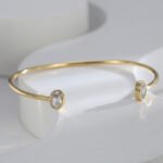 Wholesale European-style minimalist CZ cuff bracelet featuring a 14k gold plated copper design from junejewelry.com