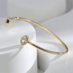 Wholesale European-style minimalist CZ cuff bracelet featuring a 14k gold plated copper design from junejewelry.com