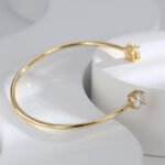 Buy Minimalist CZ cuff bangle. Simple, fashion, and adjustable, 14K gold plated open bangle feature a modern design . Free shipping at junejewelry.com.