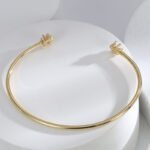 Buy Simple CZ Open Bracelet. wholesale fashion, and adjustable, 14K gold plated open bangle feature a modern design . Free shipping at junejewelry.com.