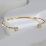 Buy Simple CZ Open Bracelet. wholesale fashion, and adjustable, 14K gold plated open bangle feature a modern design . Free shipping at junejewelry.com.