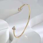 Wholesale Zircon Triangle Open Cuff Bracelet featuring a geometric triangle design with zircon stones on 14K gold-plated copper from junejewelry.com—factory price, free shipping.