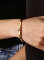 Wholesale Zircon Heart Cuff Bracelet featuring a micro‑pavé zircon heart on a 14K gold‑plated copper open cuff from junejewelry.com—factory price, free shipping.