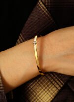 Wholesale Zircon Heart Cuff Bracelet featuring a micro‑pavé zircon heart on a 14K gold‑plated copper open cuff from junejewelry.com—factory price, free shipping.