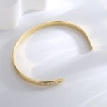 French Minimalist Gold Cuff featuring an open high‑polish 14K gold‑plated copper bracelet with a micro‑pavé zircon accent from junejewelry.com—factory price, free shipping.