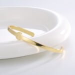 Wholesale European-style minimalist initial cuff bracelet featuring a 14k gold plated copper design from junejewelry.com