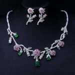 Elegant floral cubic zirconia necklace and earring set with platinum plating on a black background.