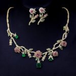 Elegant floral cubic zirconia necklace and earring set with platinum plating on a black background.