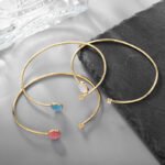 Wholesale European-style minimalist gemstone cuff bracelet featuring a 14k gold plated copper design from junejewelry.com