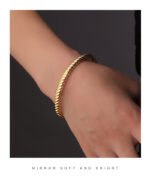 Wholesale European-style minimalist twisted cuff bracelet featuring a 14k gold plated copper design from junejewelry.com