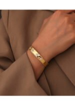 Four Leaf Clover Cuff Bracelet featuring a hollow shamrock motif with micro‑pavé zircon stones on 14K gold‑plated copper from junejewelry.com—factory price, free shipping.