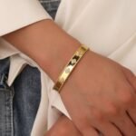 Four Leaf Clover Cuff Bracelet featuring a hollow shamrock motif with micro‑pavé zircon stones on 14K gold‑plated copper from junejewelry.com—factory price, free shipping.