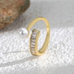 Wholesale Pearl Zircon Ring with adjustable open design, ladder-set zircon, and synthetic pearl on 18K gold-plated brass band from junejewelry.com.