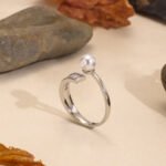 Wholesale Pearl Zircon Ring with adjustable open design, ladder-set zircon, and synthetic pearl on 18K gold-plated brass band from junejewelry.com.