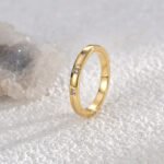 Wholesale 3 stone ring featuring a classic design with 18K gold plated copper and CZ stones from junejewelry.com