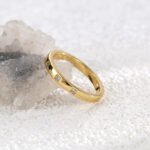 Wholesale 3 stone ring featuring a classic design with 18K gold plated copper and CZ stones from junejewelry.com
