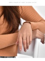 Wholesale 3 stone ring featuring a classic design with 18K gold plated copper and CZ stones from junejewelry.com