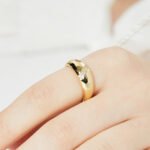 Wholesale Croissant Dome Ring in 18K gold-plated brass with glossy wide-band design, available in sizes 6 to 9 from junejewelry.com.