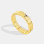 Wholesale single stone ring featuring minimalist zircon detail on a glossy 18K gold-plated brass band in sizes 6 to 9 from junejewelry.com.