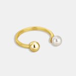 Geometric Ball Pearl Ring featuring an open copper band plated in 18K gold with a spherical bead and a freshwater pearl on opposing ends from junejewelry.com—factory price, free shipping.