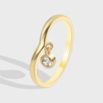 Wholesale dainty zircon ring with single cubic zirconia and 18K gold-plated copper band – stackable minimalist style from junejewelry.com.