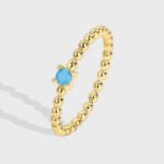 Wholesale turquoise bead ring with single round stone and gold-plated beaded band – available in 18K, platinum, and rose gold from junejewelry.com.