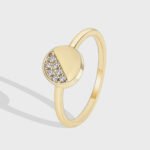 Wholesale zircon stacking ring with half pavé setting on round 18K gold-plated copper band from junejewelry.com – dainty and stackable design.