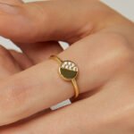Wholesale zircon stacking ring with half pavé setting on round 18K gold-plated copper band from junejewelry.com – dainty and stackable design.