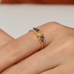 Wholesale purple zircon ring with dual stones and 18K gold-plated brass open design from JuneJewelry.com – INS minimalist style for bulk buyers.