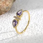 Wholesale purple zircon ring with dual stones and 18K gold-plated brass open design from JuneJewelry.com – INS minimalist style for bulk buyers.