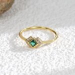 Court-Style Emerald Zircon Ring featuring an emerald-cut zircon and pavé zircon accents on a 18K gold-plated copper band from junejewelry.com—factory price, free shipping.