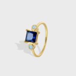 Blue Zircon Gold Ring featuring a square blue zircon on an 18K gold-plated copper band—factory-direct wholesale pricing with free shipping from junejewelry.com.