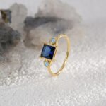 Blue Zircon Gold Ring featuring a square blue zircon on an 18K gold-plated copper band—factory-direct wholesale pricing with free shipping from junejewelry.com.