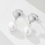 Wholesale Shell Pearl Drop Earrings, S925 sterling silver, with natural irregular freshwater pearls and a shell design, available in 18K gold or platinum plating, ideal for fashion jewelry wholesale from junejewelry.com.