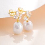 Wholesale Pearl Stud Earrings, S925 sterling silver, with natural pearls and zircon, available in 18K gold or platinum plating, ideal for fashion jewelry wholesale from junejewelry.com.