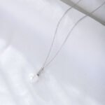 Wholesale Zircon Pearl Necklace, S925 sterling silver, with a shell pearl and zircon pendant, available in 18K gold or platinum plating, ideal for fashion jewelry wholesale from junejewelry.com.