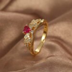 Wholesale elegant heart red zircon ring featuring an 18k gold plated copper design with a prominent red zircon and micro-pave white zircons from junejewelry.com