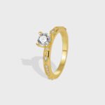 Wholesale minimalist four-prong CZ ring featuring an 18k gold plated copper design with a sparkling zircon from junejewelry.com