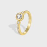 Wholesale minimalist CZ ring featuring an 18k gold plated copper design with intricate micro-pave white zircons from junejewelry.com