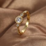 Wholesale minimalist CZ ring featuring an 18k gold plated copper design with intricate micro-pave white zircons from junejewelry.com