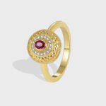 Wholesale vintage red zircon ring featuring an 18k gold plated copper design with a prominent red zircon and intricate micro-pave white zircons from junejewelry.com