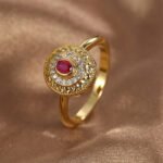 Wholesale vintage red zircon ring featuring an 18k gold plated copper design with a prominent red zircon and intricate micro-pave white zircons from junejewelry.com