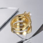 Wholesale fresh modern minimalist zircon ring for women, 18K gold plated copper with micro-pave zircons, ideal for cross-border markets from junejewelry.com