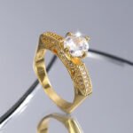 Wholesale minimalist zircon ring, 18K gold plated copper, with a sparkling zircon and unique niche design, ideal for fashion jewelry wholesale from junejewelry.com.